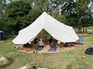 This image shows a distant photo of Nazan teaching in the yurt. Similiar to the previous image, but just further away. 