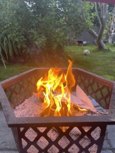 This image shows a bright fire in a metal - rusted fire pit. This is the same fire that Nazan burnt all her art work in.